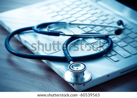 Stethoscope on silver laptop computer