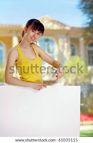 A woman holding empty white board