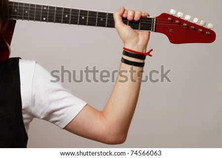 A guitarist with his guitar, focus on the instrument