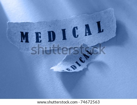 Words medical written on ripped pieces of paper