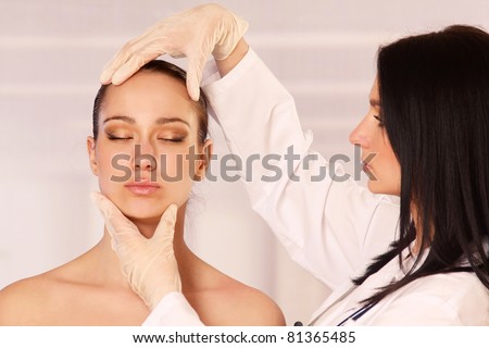 Cosmetic medicine, a doctor is examining patient\'s face