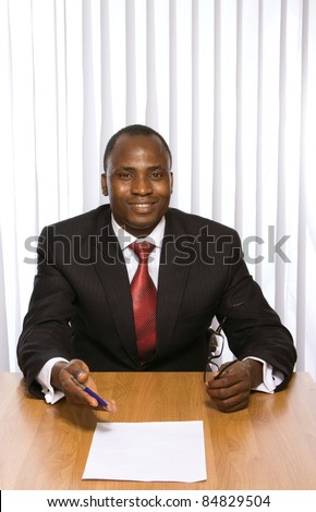 African-american signing papers at desk isolated