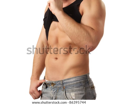 Muscular young man in black tank-top showing abs.