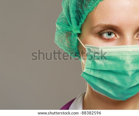 A female doctor wearing a mask, isolated on white