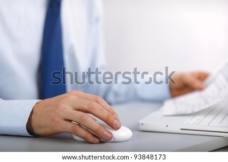 young business man using laptop and smiling