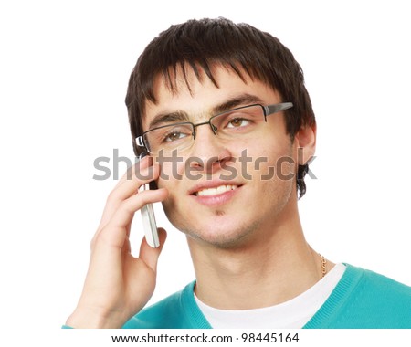 Closeup portrait of a happy young guy speaking on cellphone against white background