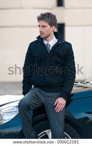 Young elegant man portrait with luxury car.