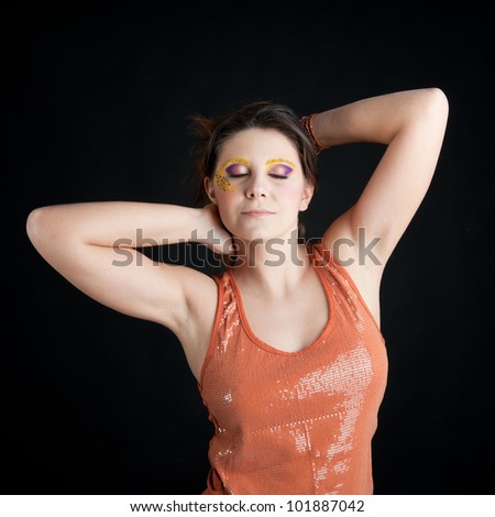 Portrait of beautiful girl with leopard make up against black background.