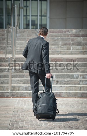 Young business man with suitcase.