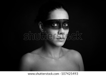 Creative makeup of beautiful girl against black background. Black and white image.