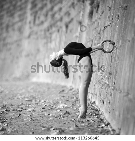 Young beautiful ballerina dancing out in Tevere riverside in Rome, Italy. Black and white image. Ballerina Project.