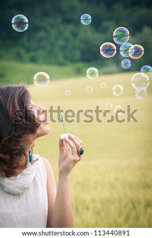 Romantic portrait of young woman with soap balloons.