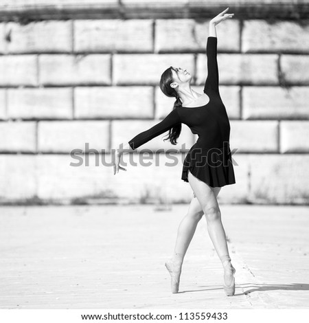 Young beautiful ballerina dancing out in Tiberina island in Rome, Italy. Black and white image. Ballerina Project.