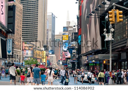 NEW YORK CITY - JUNE 28: People walking in Times Square, a busy tourist intersection of commerce Advertisements and a famous street of New York City and US, seen on June 28, 2012 in New York, NY.