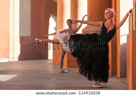Young beautiful ballerinas dancing in front of St. Luca church. Bologna, Italy.