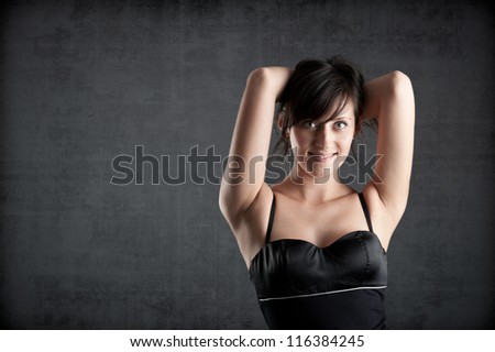Beautiful woman close up portrait against dark grunge background.