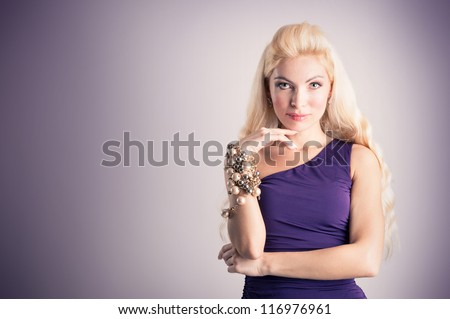 Elegant blonde woman with purple dress.