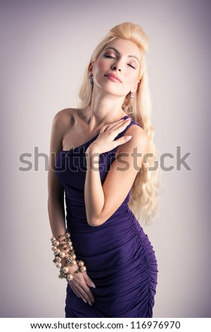 Elegant blonde woman with purple dress.