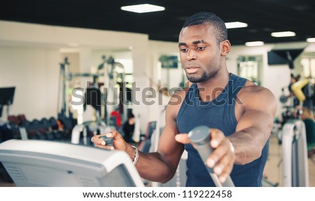 Young black man training in the gym.