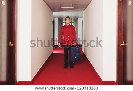 Porter man with trolley during service in a hotel.