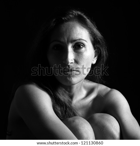 Beautiful middle age woman close up portrait. Black and white image.