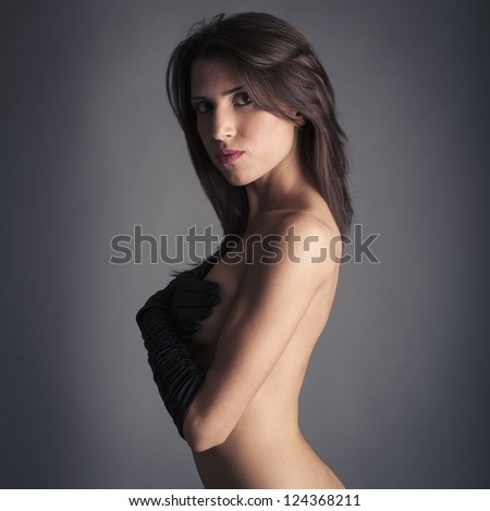Young woman with long gloves beauty portrait against dark background.