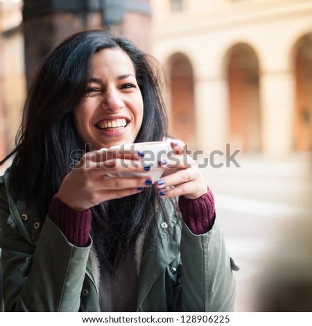 Young woman drinking coffee in a cafe outdoors Shallow depth of field Young woman drinking coffee in a cafe outdoors Shallow depth of field