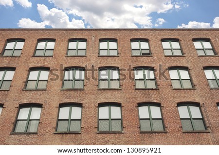 Facade of an old red brick apartment building in Brooklyn, New York.