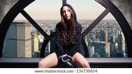 Boxer woman portrait relaxing in dressing room with New York skyline in the background.