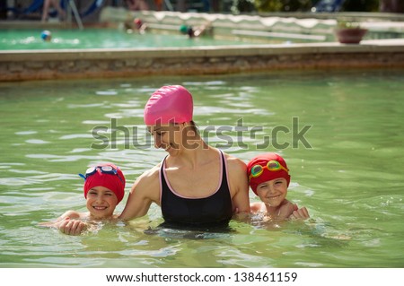 Mother and sons in thermal swimming pool.