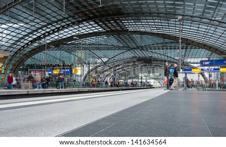 BERLIN - JUNE 2: People attending trains at the Berlin Central train station on 2 June 2013 in Berlin, Germany. It is the is the main railway station in Berlin with a surface area of 85 by 120 mt.