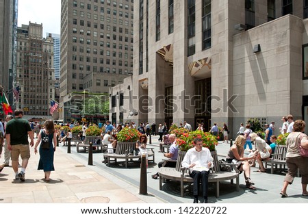 New York - July 3: People At The Base Of Rockefeller Center On July 3, 2012 In New York. It Was Built By The Rockefeller Family In 1939 And Was Declared A National Historic Landmark In 1987.