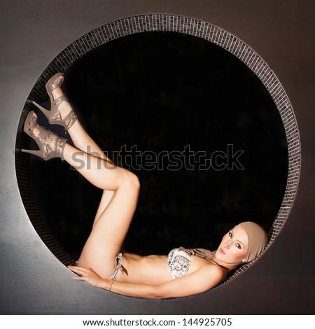 Beautiful sexy woman posing in circle wearing swimsuit.