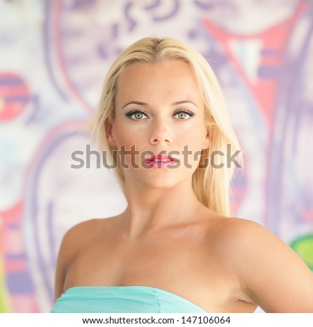 Sensual blonde woman portrait with colorful drawings as background.