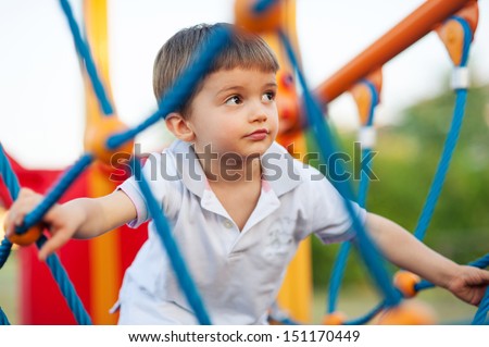 3 year old kid in a playground outdoor.