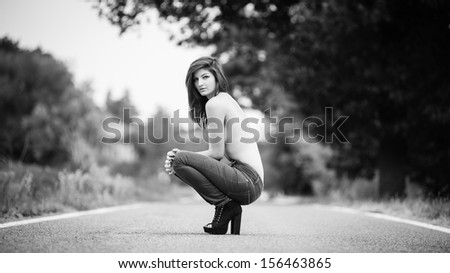 Young woman portrait on the road. Black and white image.