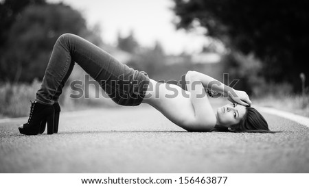 Young woman portrait on the road. Black and white image.