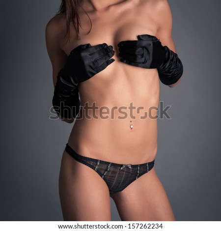Sensual woman with long gloves beauty portrait against dark background.