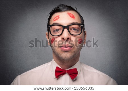 Portrait Of Young Nerd With Kiss Imprints Isolated On Grunge Background.