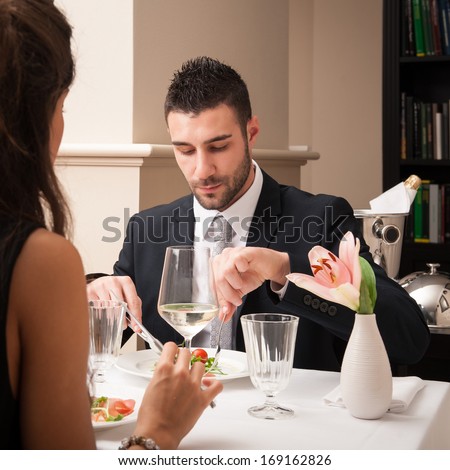 Attractive elegant young couple having dinner at the restaurant.
