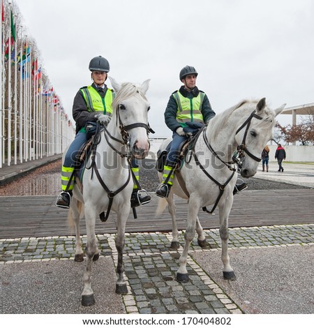 LISBON, PORTUGAL - JANUARY 2, 2014: Public Security Police officers riding horses. The PSP was formed by King Luis with the publication of a law which founded the corp of civil police in 1867.