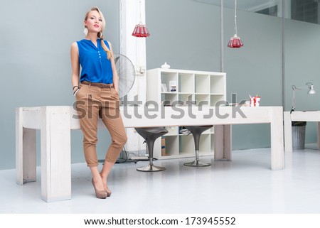 Business woman full body portrait in modern office.