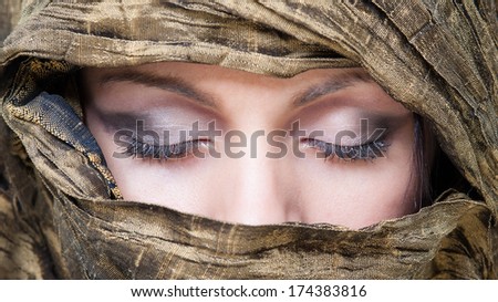 Portrait of veiled woman with closed eyes.