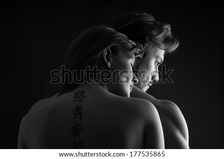 Young couple close up intimate studio portrait in a romantic mood. Black and white image.