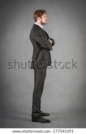 Young man full body portrait against grunge background.