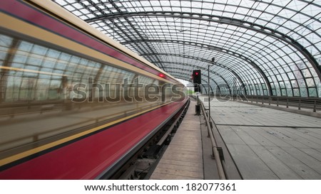 BERLIN - JUNE 2, 2013: Train passing in Berlin Central train station. It is the main railway station in Berlin with a surface area of 85 by 120 mt.