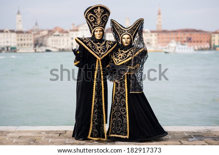 Carnival of Venice, beautiful masks at St. George island with Mark\'s Square in the background.