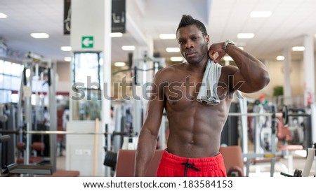 Strong black man having a pause in the gym.