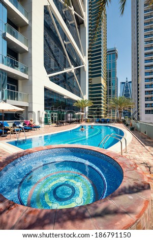 DUBAI, UAE - MARCH 28, 2014: Swimming pool of Indigo Tower. In Dubai there is a high concentration of swimming pools due to climate conditions and the high pro capital income.