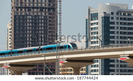 DUBAI, UAE - MARCH 27, 2014: Train approaching Jumeirah Lakes Tower metro station. The JLT is a large development which consists of 79 towers being constructed along the edges of 4 artificial lakes.
